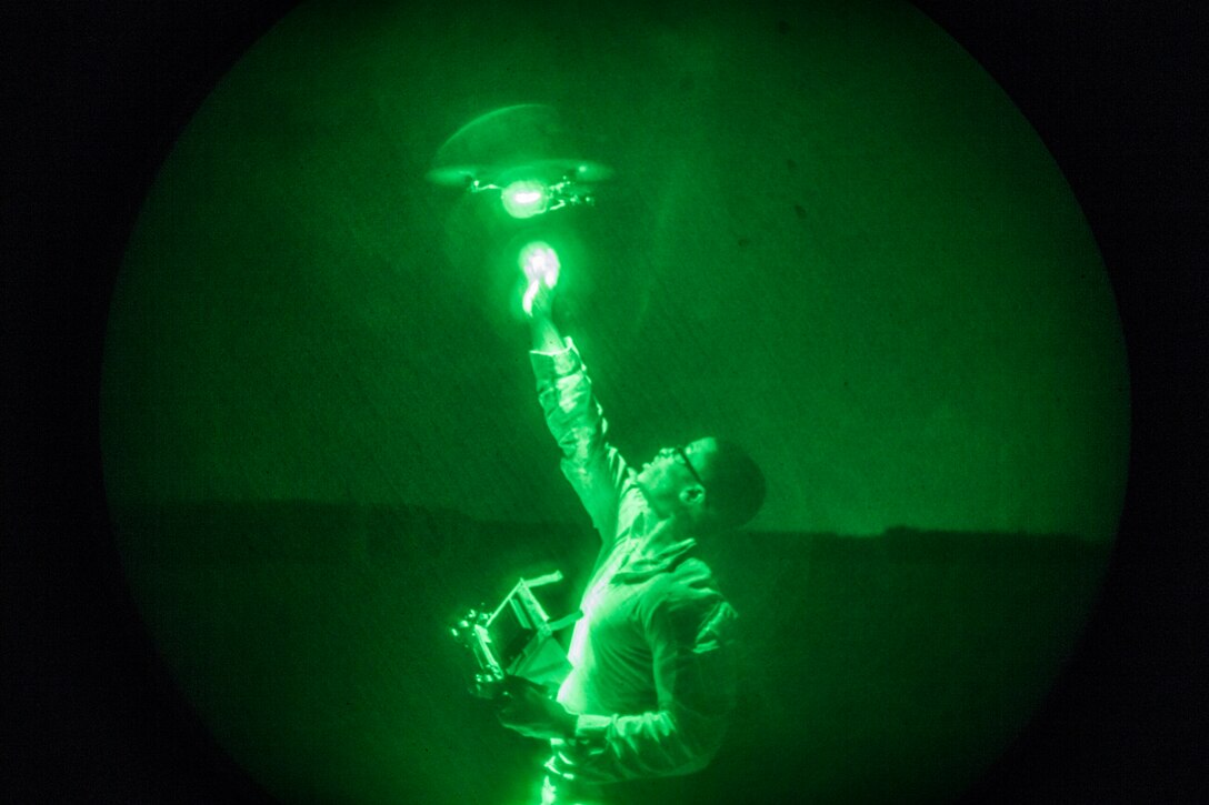 UNDISCLOSED LOCATION, SOUTHWEST ASIA – U.S. Marine Corps Cpl. Justin Johnson, an intelligence analyst with 3rd Battalion 7th Marine Regiment attached to Special Purpose Marine Air-Ground Task Force, Crisis Response-Central Command (SPMAGTF-CR-CC), recovers an Instant Eye quadcopter system out of the night sky July 27, 2018. SPMAGTF-CR-CC Marines regularly support Task Force Spartan, whose mission is to advise and assist Iraqi forces in the Ramadi area. (U.S. Marine Corps photo by Cpl. Gabino Perez)