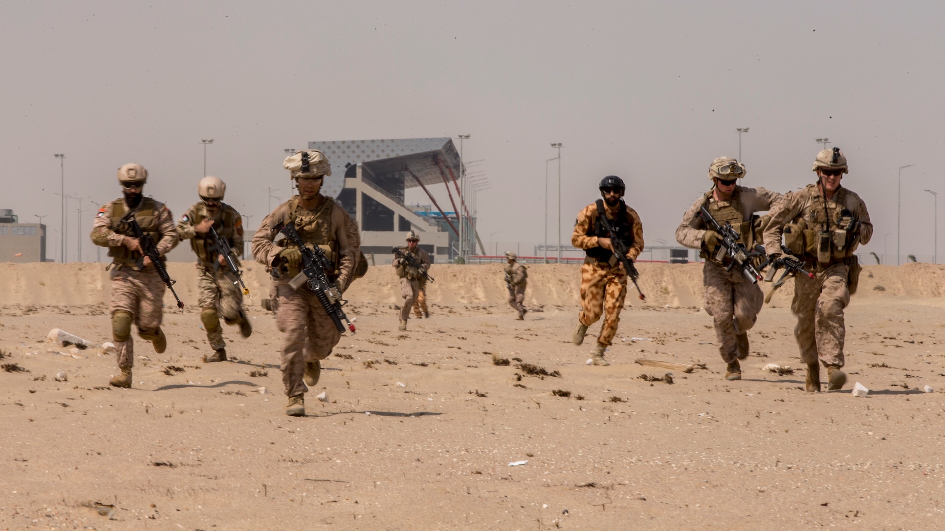 UNDISCLOSED LOCATION, SOUTHWEST ASIA – U.S. Marines with 3rd Battalion 7th Marine Regiment, 1st Marine Division attached to Special Purpose Marine Air-Ground Task Force, Crisis Response-Central Command and Kuwait Armed Forces service members rush to their objective during exercise Invincible Sentry August 8, 2018. SPMAGTF-CR-CC works with partner nations on maintaining regional security through joint operations and exercises. (U.S. Marine Corps photo by Cpl. Gabino Perez)