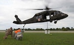 1st Lt. Adam Brewer (left), Tech. Sgt. Steven Rose and Senior Airman Jeremiah Mata, 26th Aerial Port Squadron, aerial transportation technicians, provide a thumbs-up