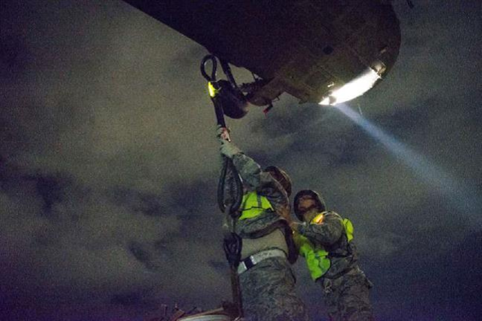 Senior Airman Jerimiah Mata (right) braces Tech. Sgt. Steven Rose, 26th Aerial Port Squadron, aerial transportation technicians