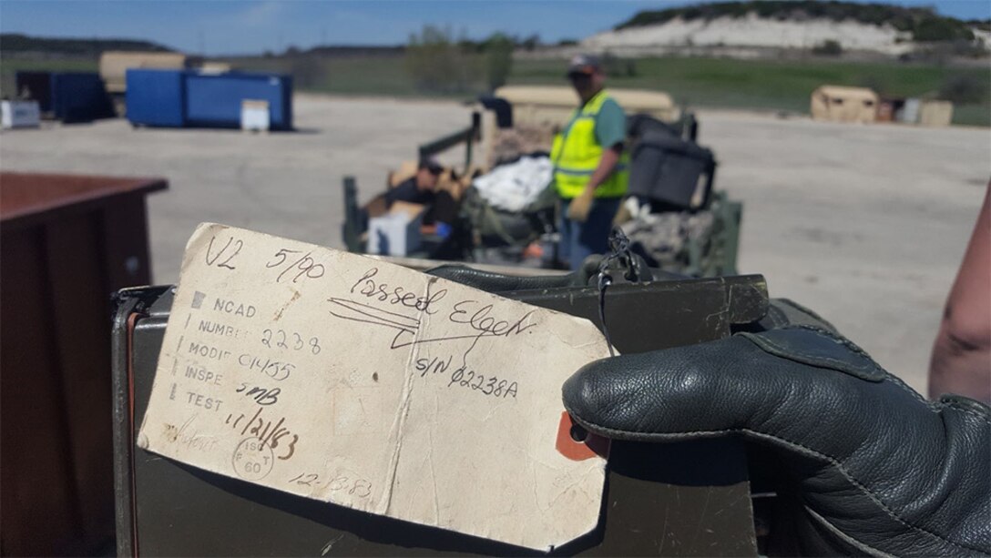 Lt. Gen. Paul Funk II, the III Corps and Fort Hood commander, holds a tag during the Fort Hood Clean Sweep Surge Event while explaining that he was a senior at Montana State University when a chemical detector passed its most recent readiness inspection on December 13, 1983.