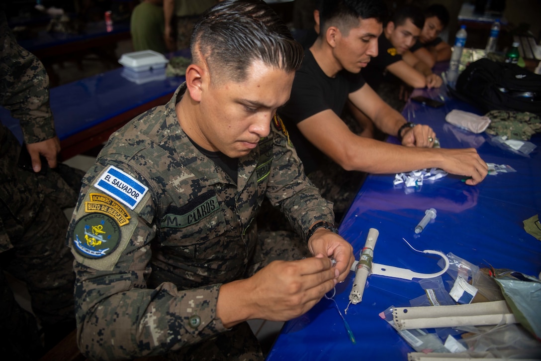 A Salvadoran military professional participates in a cricothyroidotomy application subject matter expert exchange