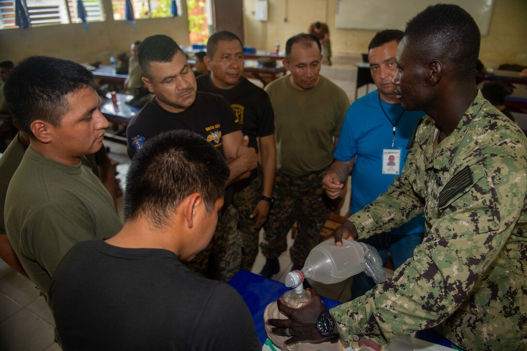 A Salvadoran military professional participates in a cricothyroidotomy application subject matter expert exchange