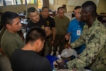 A Salvadoran military professional participates in a cricothyroidotomy application subject matter expert exchange