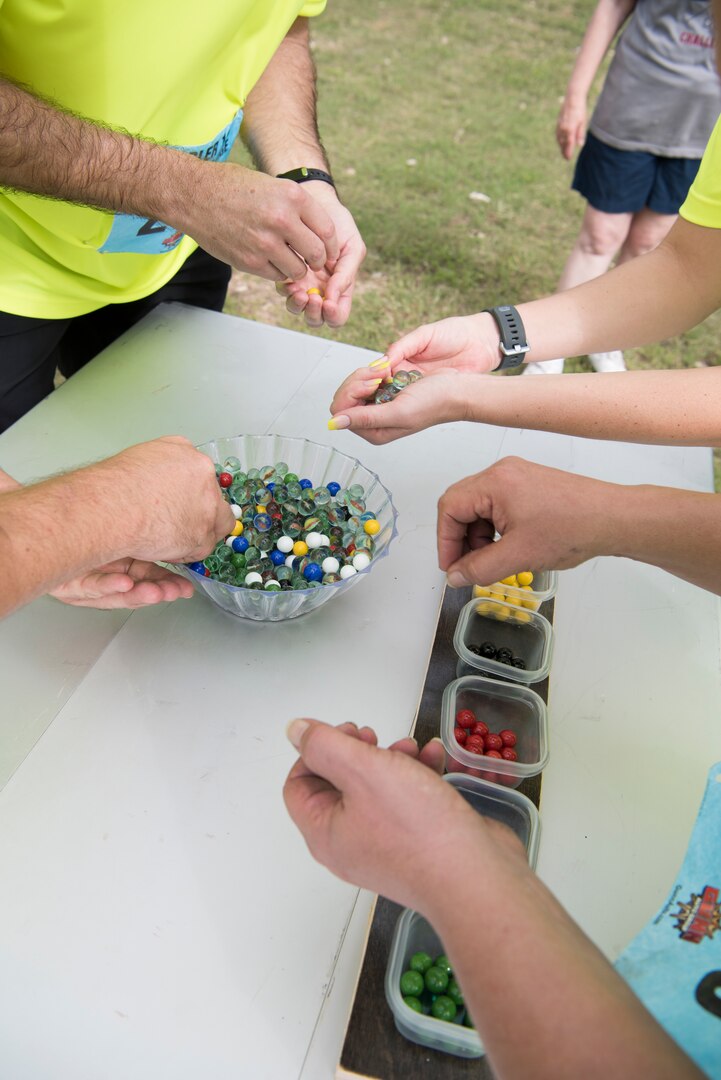 A team competing in the annual Rambler 120 Oct. 13, 2018, sorts out marbles as part of the mystery event of the competition at Joint Base San Antonio Recreation Area at Canyon Lake, Texas.