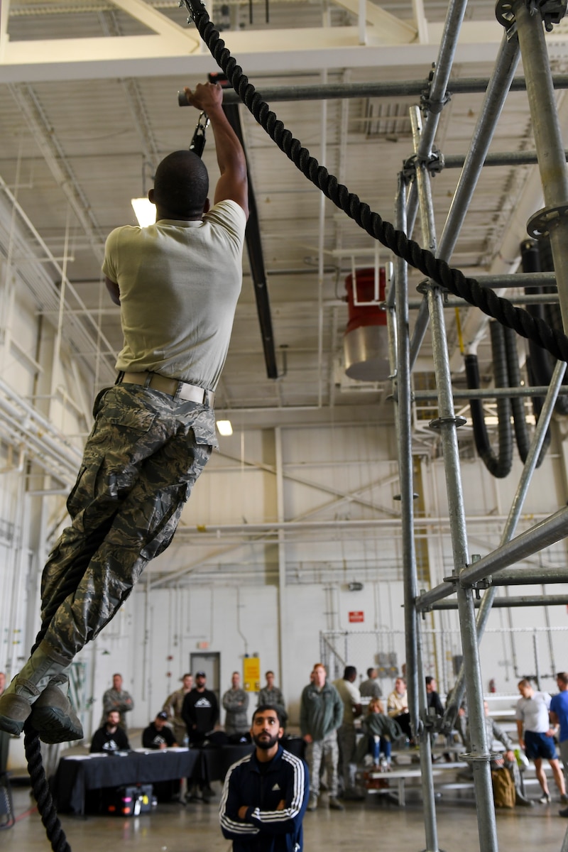 An Airman with the 911th Airlift Wing participates in a time challenge using the Alpha Warrior Battle Rig at the Pittsburgh International Airport Air Reserve Station, Pennsylvania, October 14, 2018. The battle rig is designed to meet all four of the Comprehensive Airman Fitness model's pillars: mental, physical, social and spiritual. (U.S. Air Force photo by Senior Airman Beth Kobily)
