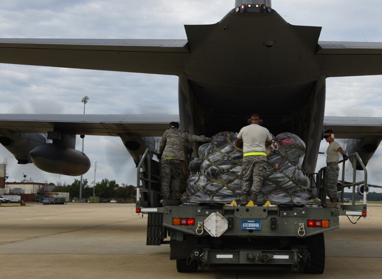 U.S. Air Force Airmen from the 733rd Logistics Readiness Squadron small air terminal assist the 71st Rescue Squadron loadmasters with the gear and supplies being sent to Tyndall Air Force Base, Florida, onto a HC-130J Combat King II at  Joint Base Langley-Eustis, Virginia, Oct. 17, 2018. The HC-130J is from the 71st Rescue Squadron at Moody Air Force Base, Georgia. (U.S. Air Force photo by Staff Sgt. Carlin Leslie/Released)
