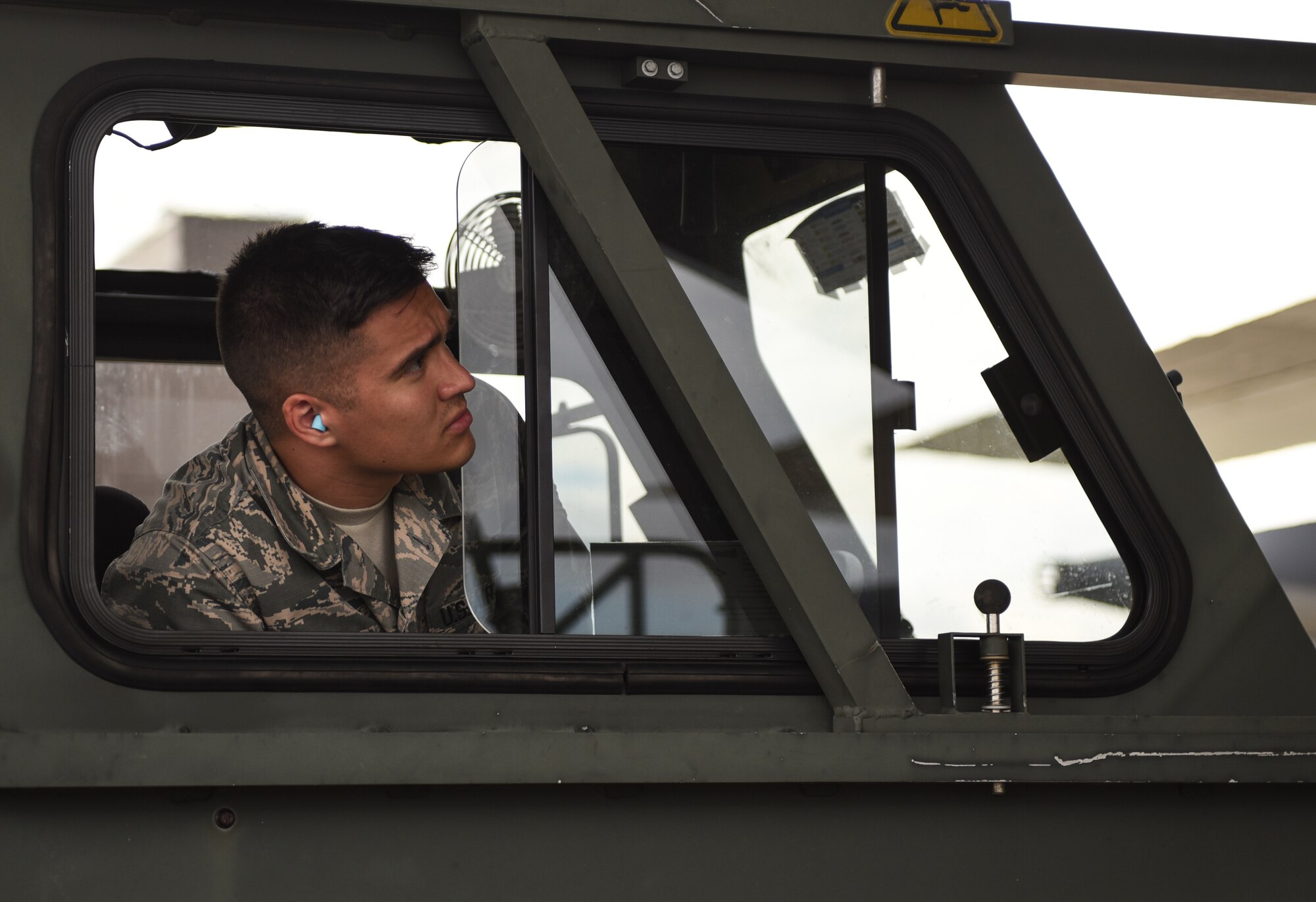 U.S. Air Force Airman First Class Jaxson Doyle, 733rd Logistics Readiness Squadron small air terminal representative, watches loading operations from the K-loader in support of recovery efforts for Tyndall Air Force Base, Florida, at Joint Base Langley-Eustis, Virginia, Oct. 17, 2018. The supplies and gear being loaded are for recovery efforts of Tyndall Air Force Base, Florida. (U.S. Air Force photo by Staff Sgt. Carlin Leslie/Released)