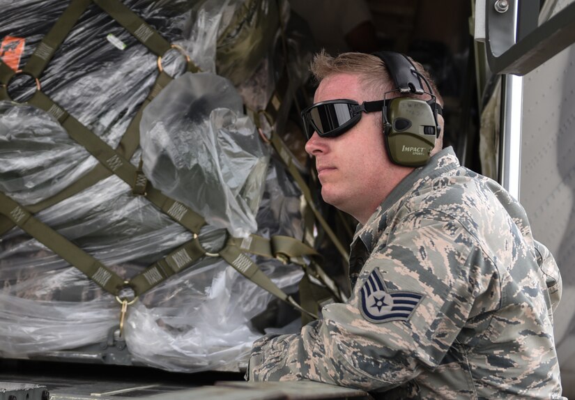 U.S. Air Force Staff Sgt. John Wilson, 733rd Logistics Readiness Squadron deployment readiness, waits for the order to pull chaulks during a loading operation supporting the Tyndall Air Force Base, Florida, recovery efforts at Joint Base Langley-Eustis, Virginia, Oct. 17, 2018. The HC130J Combat King II is from the 71st Rescue Squadron at Moody Air Force Base, Georgia. (U.S. Air Force photo by Staff Sgt. Carlin Leslie/Released)