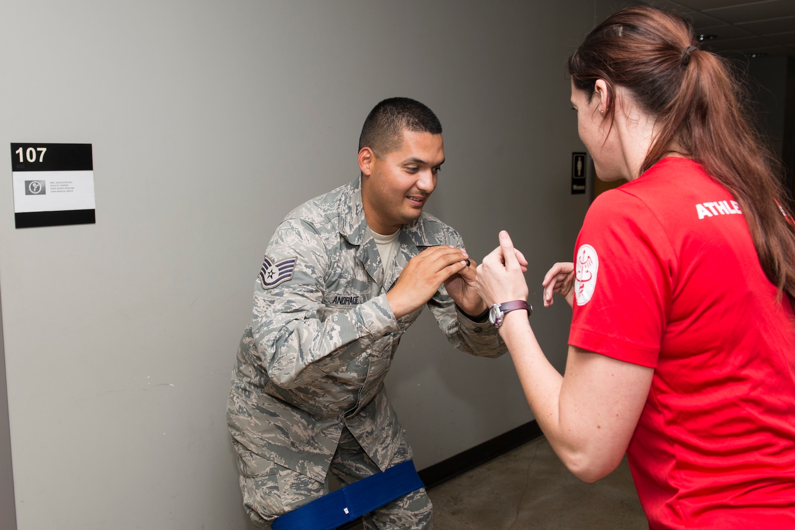 Jacquelyn Hale, a 343rd Training Squadron athletic trainer, walks a 343rd TRS instructor through physical training exercises