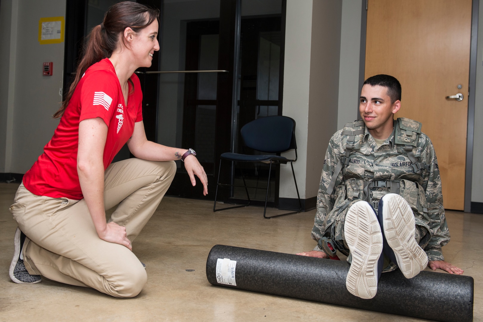 Jacquelyn Hale, a 343rd Training Squadron athletic trainer, walks a 343rd TRS trainee through physical training exercises