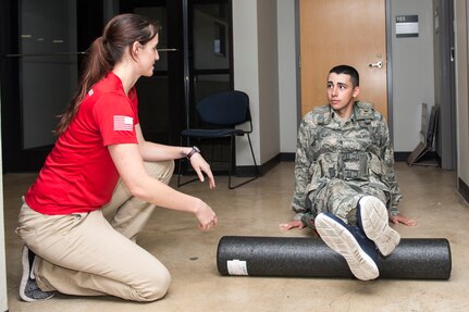 Jacquelyn Hale, a 343rd Training Squadron athletic trainer, walks a 343rd TRS trainee through physical training exercises