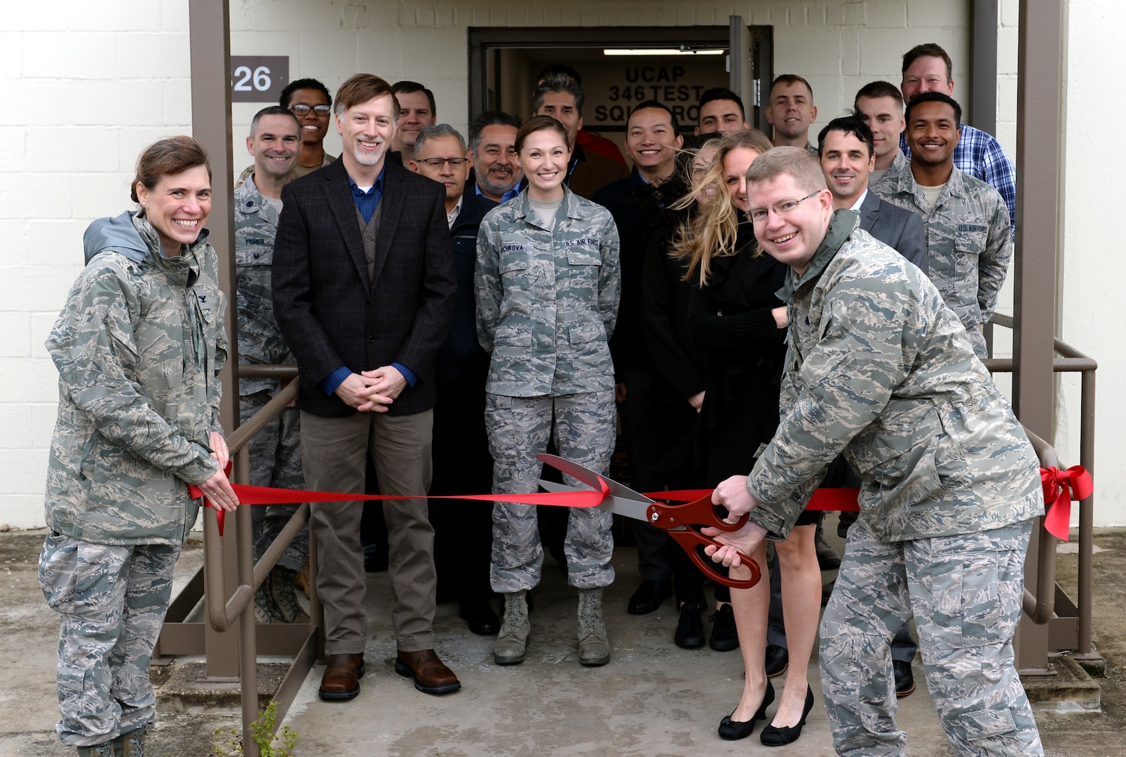 Members of the 346th Test Squadron, Unified Capabilities Assessment Program team cut the ribbon during a ceremony at Joint Base San Antonio-Lackland Oct. 15. The ceremony was hosted to welcome the UCAP team to its new home. The team provides Department of Defense Information Network Approved Products List testing of communications equipment before the equipment can be connected to the DODIN. UCAP is the only Air Force lab that provides DODIN APL testing and results are accepted DOD-wide.