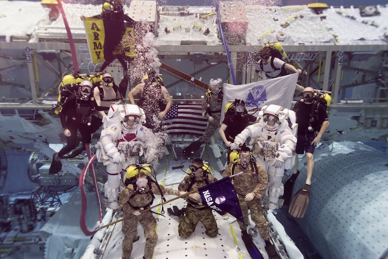 Army astronauts Col. Andrew "Drew" Morgan and Lt. Col. Anne McClain, both from the astronaut class of 2013, prepare to be promoted while underwater following required training in the Neutral Buoyancy Laboratory at the Sonny Carter Training Facility in Houston, Texas, Sept. 27.