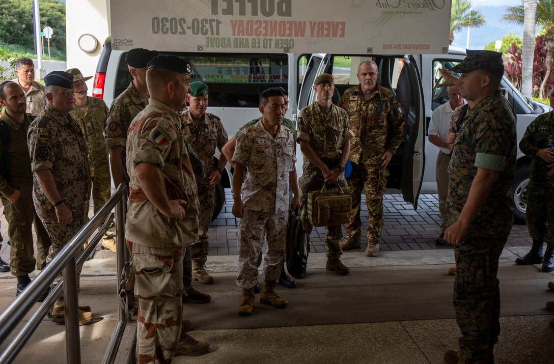 U.S. Marine Corps Lt. Col. Bryan Edwards (right), current operations officer, S-3, Marine Corps Base Hawaii (MCBH), greets U.S. and foreign Service members with U.S. Army Training Doctrine Command (TRADOC) liaisons at the Officer’s Club during a tour of MCBH, Oct. 16, 2018. TRADOC liaisons visited the base to learn about the advantages of the unique training areas around Hawaii. (U.S. Marine Corps photo by Sgt. Zachary Orr)