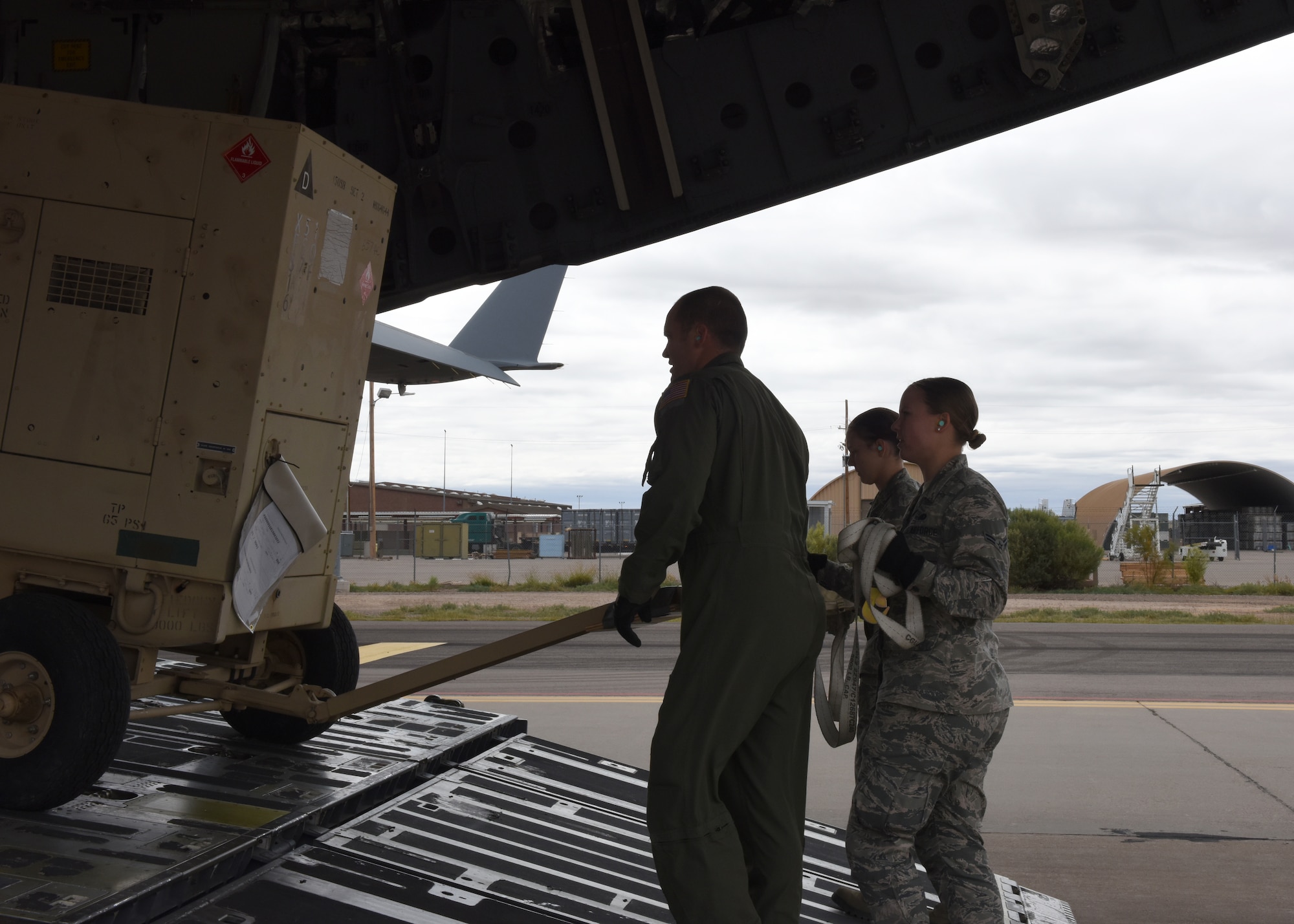 Airmen from the 49th Logistics Readiness Squadron and the 635th Materiel Maintenance Group lock equipment into place, Oct. 15, 2018, on a C-17 Globemaster III, assisted to the Memphis Air National Guard, on the flightline at Holloman Air Force Base, N.M. The 49th LRS supported Airmen from the 635th MMG in a recent operation to send essential supplies to Tyndall Air Force Base, Fla. (U.S. Air Force photo by Airman Autumn Vogt)