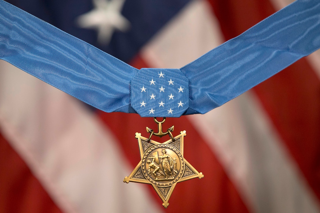 View of the Medal of Honor, with an American flag as the backdrop.