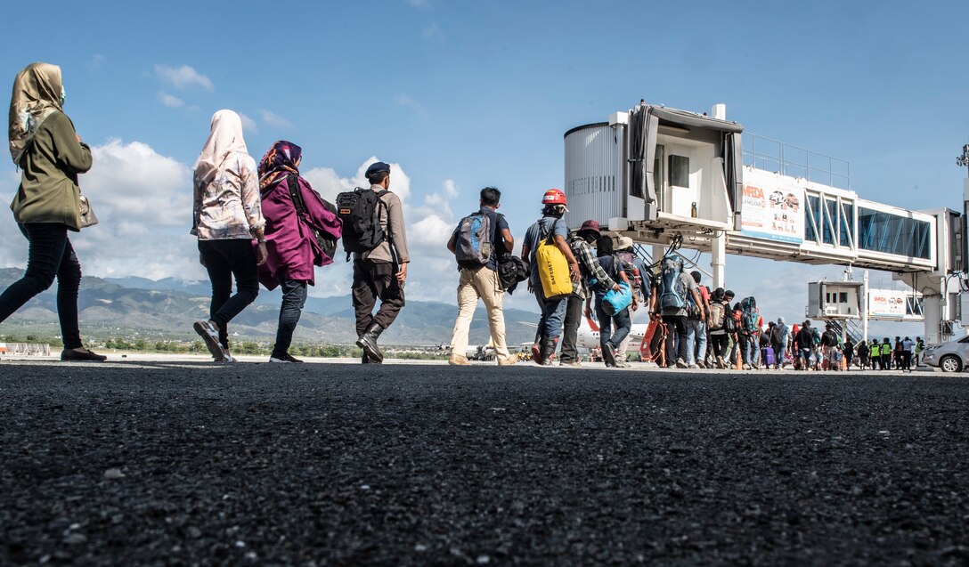 Hundreds of displaced people from Indonesia prepare to board an Indonesian C-130 aircraft in Palu, Indonesia Oct. 10, 2018. Thousands were displaced after a 7.5 magnitude earthquake and tsunami struck Indonesia’s Sulawesi Island Sept. 28, 2018. The Indonesian Government and U.S. Agency for International Development are working alongside eight countries agencies and foreign militaries ensuring supplies, airlift, shelter and medical support reach those affected. (U.S. Air Force photo by Master Sgt. JT May III)