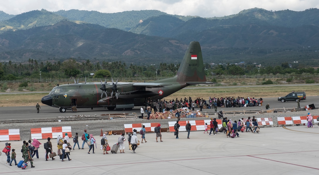 Hundreds of displaced people from Indonesia prepare to board an Indonesian C-130 aircraft in Palu, Indonesia Oct. 10, 2018. Thousands were displaced after a 7.5 magnitude earthquake and tsunami struck Indonesia’s Sulawesi Island Sept. 28, 2018. The Indonesian Government and U.S. Agency for International Development are working alongside eight countries agencies and foreign militaries ensuring supplies, airlift, shelter and medical support reach those affected. (U.S. Air Force photo by Master Sgt. JT May III)