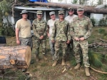 Brig. Gen. Randall Simmons, commander of the Georgia Army National Guard and Command Sgt. Major Jeff Logan, senior enlisted advisor of the 201st Regional Support Group, stand with 1st Lt. Christopher Long of the Augusta-based 877th Engineer Company and Tech Sgt. Eric Glass, Tech Sgt. Lauren Swanson and Tech Sgt. Anthony McDonnell of the Warner Robins-based 116th Air Control Wing following their emergency actions in Seminole County.