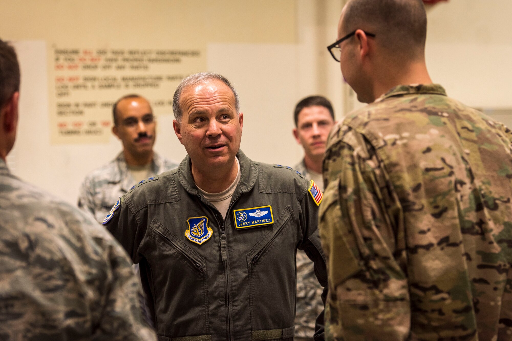 U.S. Air Force Lt. Gen. Jerry P. Martinez, center, the U.S. Forces Japan and Fifth Air Force commander, talks with Tech. Sgt. Jordon Jones, right, a 35th Maintenance Squadron aircraft structural maintenance craftsman, during his visit at Misawa Air Base, Japan, Oct. 11, 2018. The general, joined by his command chief, Chief Master Sgt. Terrence Greene, engaged with Airmen across the installation, sharing their perspective on how the 35th Fighter Wing supports the broader strategic objectives in the defense of Japan. (U.S. Air Force photo by Tech. Sgt. Benjamin W. Stratton)
