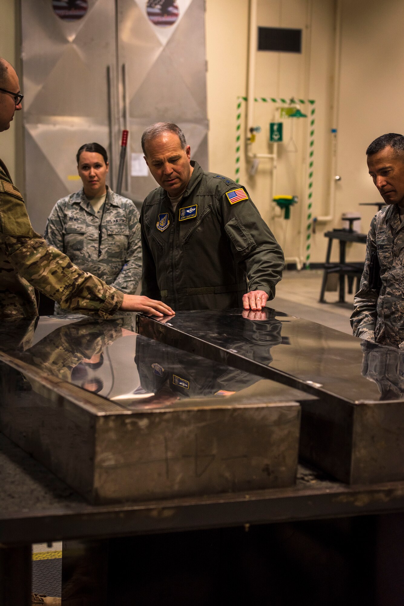 U.S. Air Force Tech. Sgt. Jordon Jones, left, a 35th Maintenance Squadron aircraft structural maintenance craftsman, explains to Lt. Gen. Jerry P. Martinez, center, the U.S. Forces Japan and Fifth Air Force commander, and his command chief, Chief Master Sgt. Terrence Greene, right, the significance of adding pieces of sheet metal to engine test facility equipment during their visit at Misawa Air Base, Japan, Oct. 11, 2018. The chief said USFJ’s Airmen are incredibly talented when it comes to innovative ideas and continue stepping up, making every dollar count and saving taxpayer dollars. (U.S. Air Force photo by Tech. Sgt. Benjamin W. Stratton)