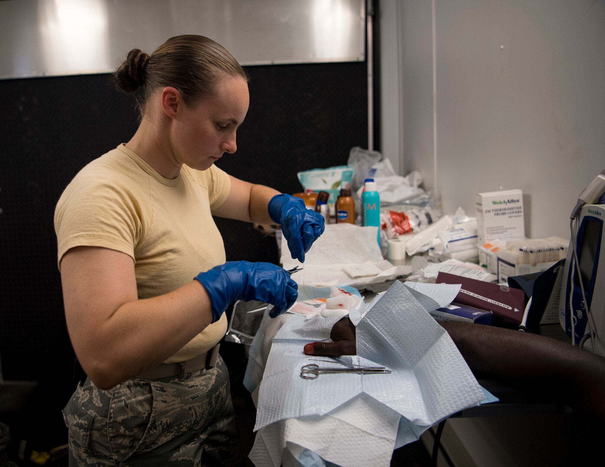 U.S. Air Force Staff Sgt. Jessica Ewens, a 96th Aeromedical Squadron independent duty medical technician out of Eglin Air Force Base, Florida, provides medical care to a patient inside a mobile medical clinic at Tyndall Air Force Base, Florida, Oct. 17, 2018. Support personnel from Tyndall and other bases were on location to support Airmen returning to their homes to assess damage and collect personal belongings. (U.S. Air Force photo by A1C Kelly Walker)