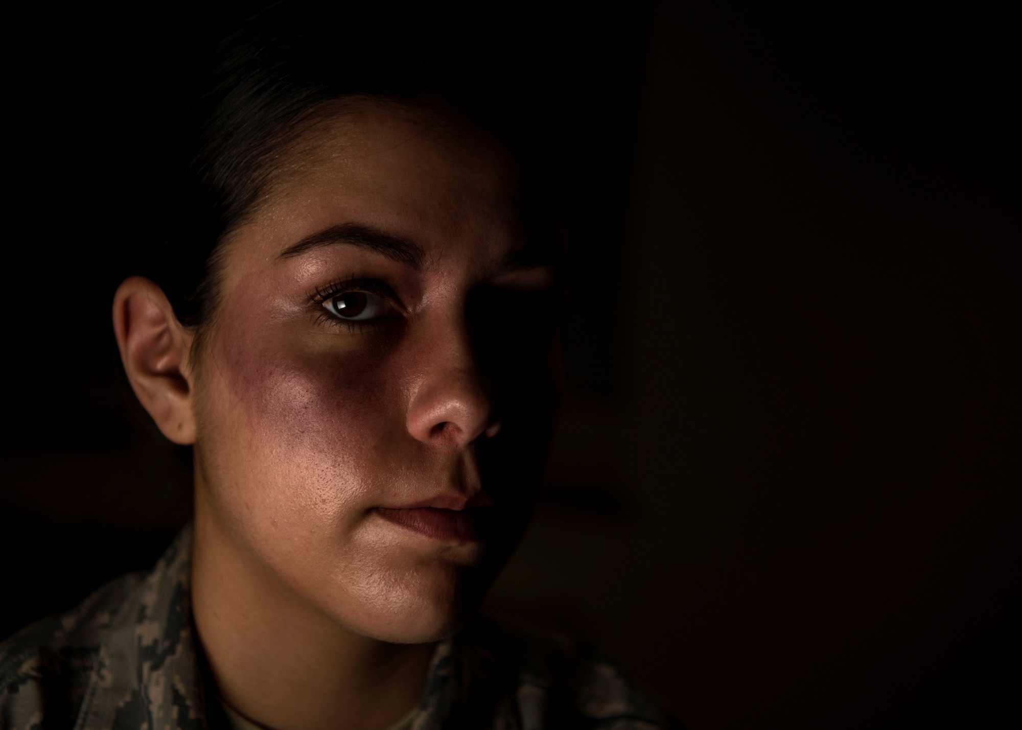 U.S. Air Force Senior Airman Miranda Gollnick, 52nd Logistic Readiness Squadron material management technician, poses for a portrait while wearing moulage makeup at Spangdahlem Air Base, Germany, Oct. 17, 2018. Gollnick volunteered to simulate a victim of domestic violence for one day in support of the Black Eye Campaign. The social experiment was held to raise awareness of domestic violence. (U.S. Air Force photo by Airman 1st Class Valerie Seelye)