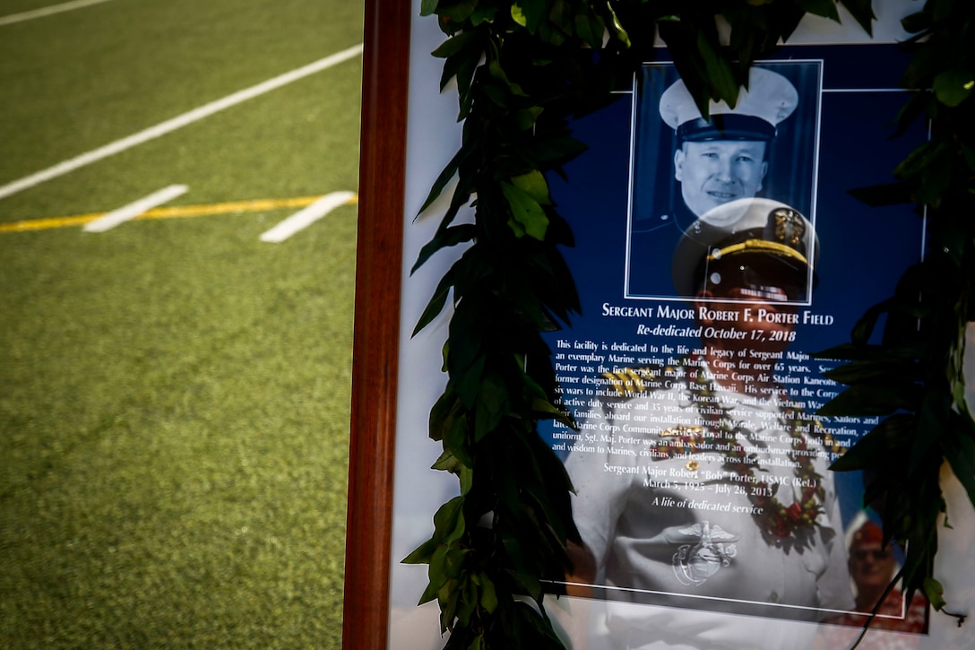 U.S. Navy Cmdr. David Porter's (retired) reflection is depicted on Sgt. Maj. Robert E. Porter's framed portrait during the rededication ceremony of Sergeant Major Robert E. Porter Field, Marine Corps Base Hawaii, Oct. 17, 2018. Sgt. Maj. Robert Porter served 30 years in the Marines Corps, which included service in World War II, Korea and two tours in Vietnam. He was also the first sergeant major of Marine Corps Air Station Kaneohe, Hawaii. Porter passed away at the age of 88 on July 28, 2013.