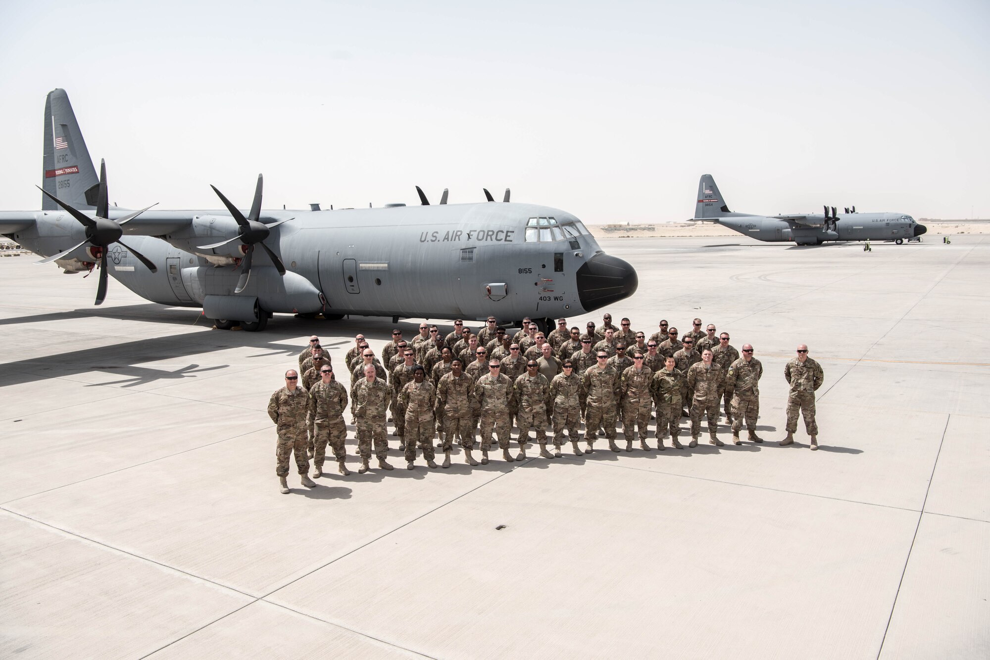 Members of the Air Force Resever 803rd Maintenance Squadron pose with a Flying Jennies C-130J.  The 803rd AMXS completed its first deployment since its induction into the 403rd Wing.   (U.S. Air Force photo by 403rd Wing Public Affairs)