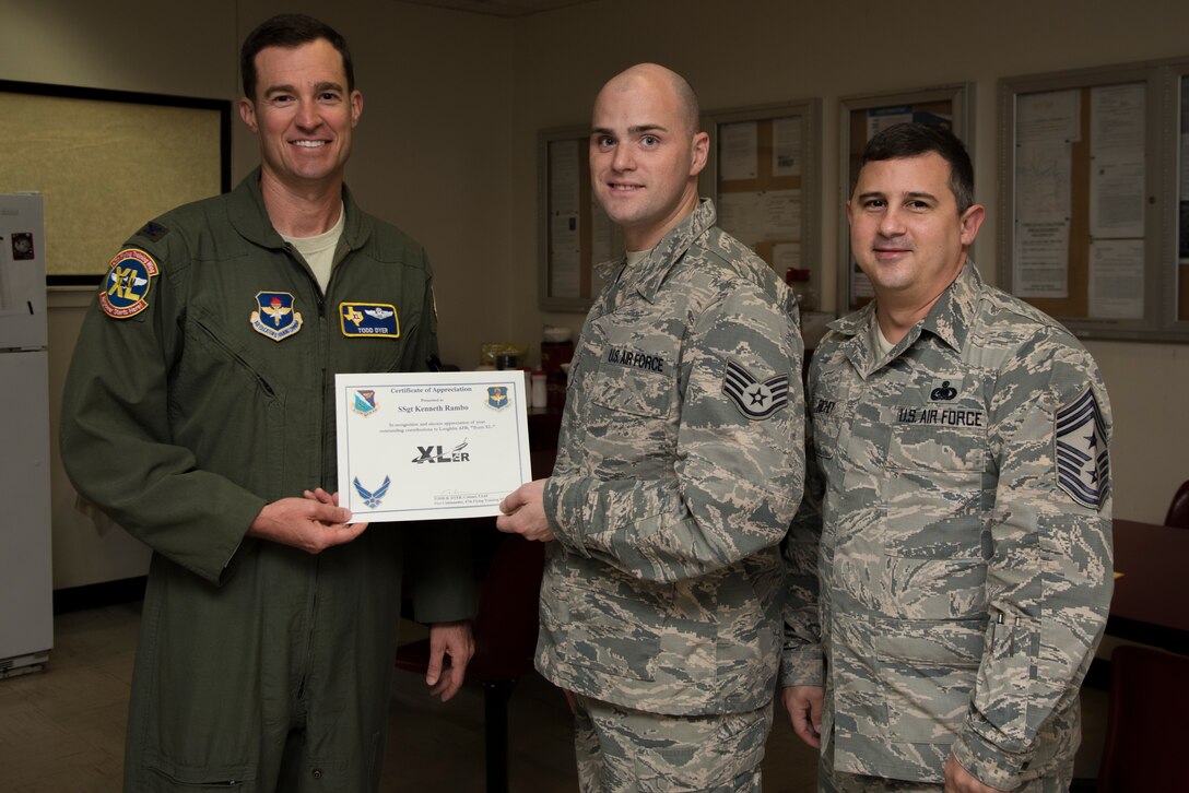 Staff Sgt. Kenneth Rambo, 47th Flying Training Wing egress systems craftsman, was chosen by wing leadership to be the “XLer” of the week, for the week of Oct. 8, 2018, at Laughlin Air Force Base, Texas. The “XLer” award, presented by Col. Todd Dyer, 47th Flying Training Wing vice commander, is given to those who consistently make outstanding contributions to their unit and the Laughlin mission. (U.S. Air Force photo by Airman 1st Class Marco A. Gomez)
