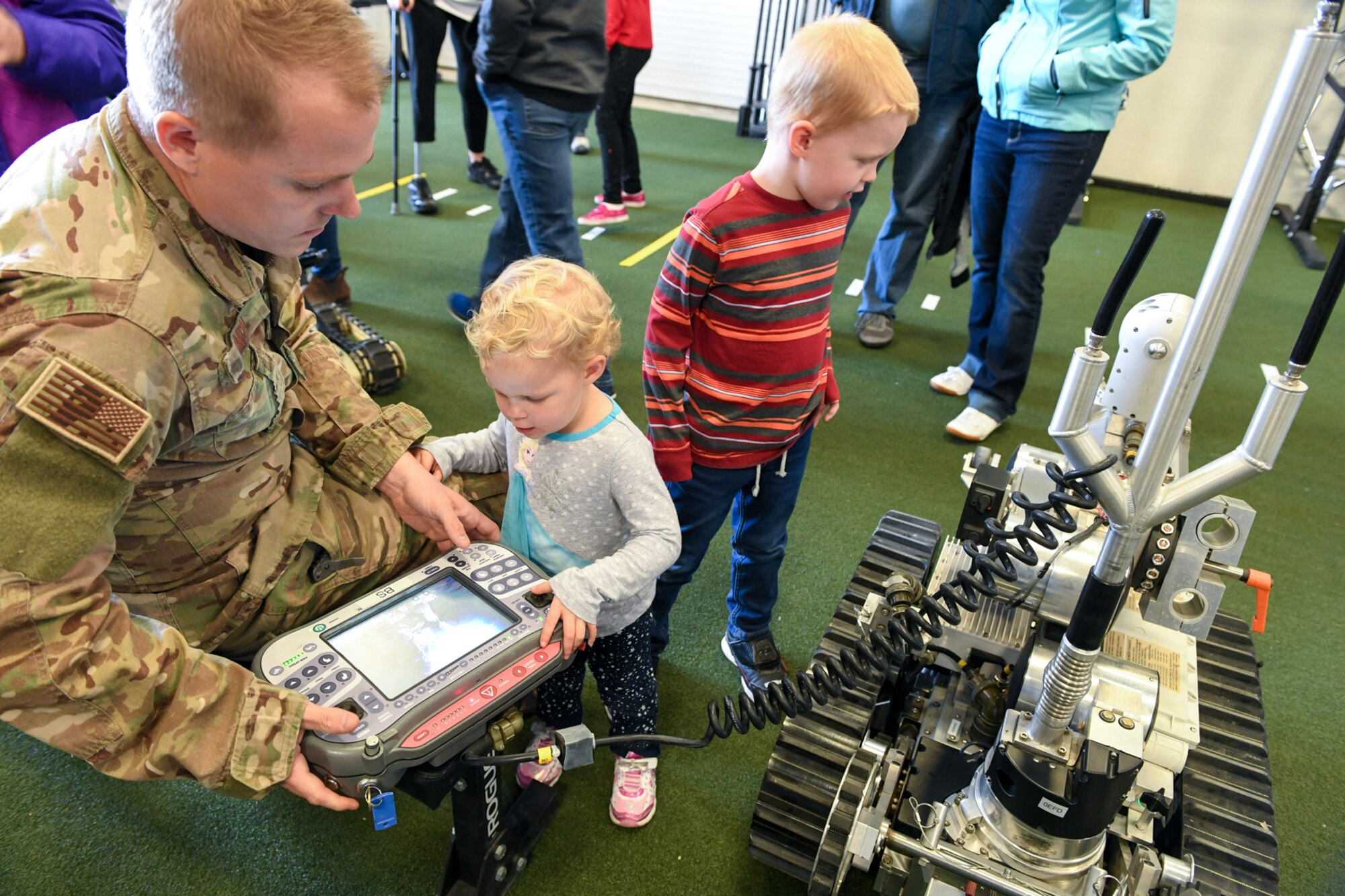 Staff Sgt. Terry Smith, 775th Explosive Ordinance Disposal Flight, shows Gracie and Wesley Michelsen how to operate a robot during a visit to EOD Oct. 11, 2018, at Hill Air Force Base, Utah. The visit was part of a 75th Air Base Wing-hosted base tour for Make-A-Wish Utah children and their families. (U.S. Air Force photo by Cynthia Griggs)