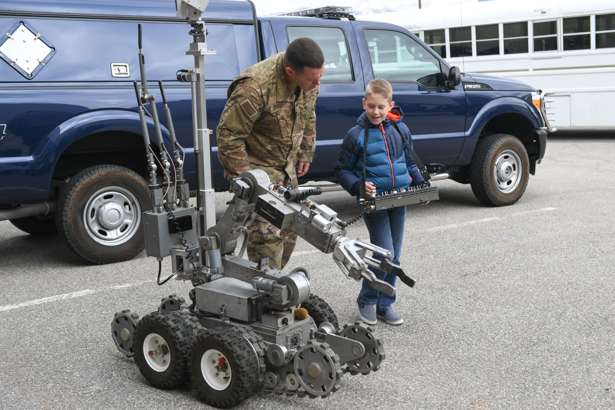 Senior Airman David Andrews, 775th Explosive Ordinance Disposal Flight, lets Eli Names control a robot during a visit to EOD Oct. 11, 2018, at Hill Air Force Base, Utah. The visit was part of a 75th Air Base Wing-hosted base tour for Make-A-Wish Utah children and their families. (U.S. Air Force photo by Cynthia Griggs)