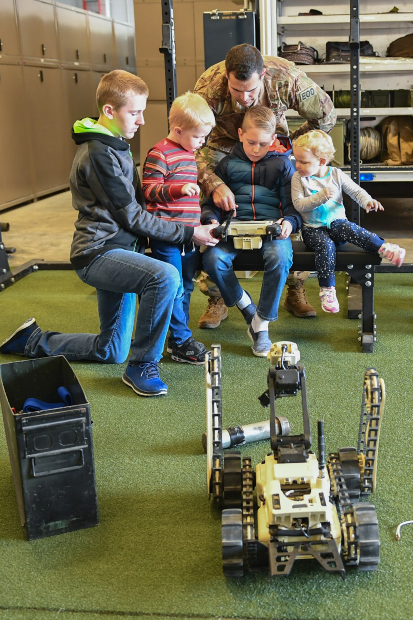 Capt. Nathan Demers, 775th Explosive Ordinance Disposal Flight, helps children operate a robot during a visit to EOD Oct. 11, 2018, at Hill Air Force Base, Utah. The visit was part of a 75th Air Base Wing-hosted base tour for Make-A-Wish Utah children and their families. (U.S. Air Force photo by Cynthia Griggs)