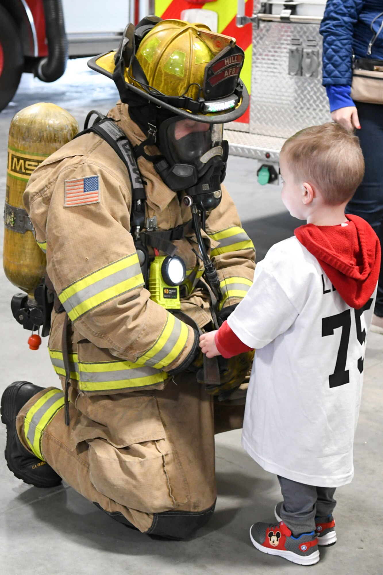 Clark Lenehan greets Duncan Hutchinson, a firefighter with 775th Civil Engineering Squadron, during a visit to the fire department Oct. 11, 2018, at Hill Air Force Base, Utah. The visit was part of a 75th Air Base Wing-hosted base tour for Make-A-Wish Utah children and their families. (U.S. Air Force photo by Cynthia Griggs)