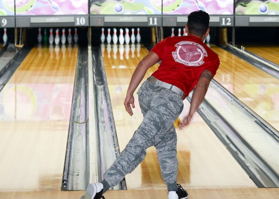 An Airman with the 412th Aerospace Medicine Squadron, watches his bowling ball roll down the lane during the “Strike Out Sexual Assault” event at the High Desert Bowling Lanes on Edwards Air Force Base, California, Oct. 12. (U.S. Air Force photo by Giancarlo Casem)