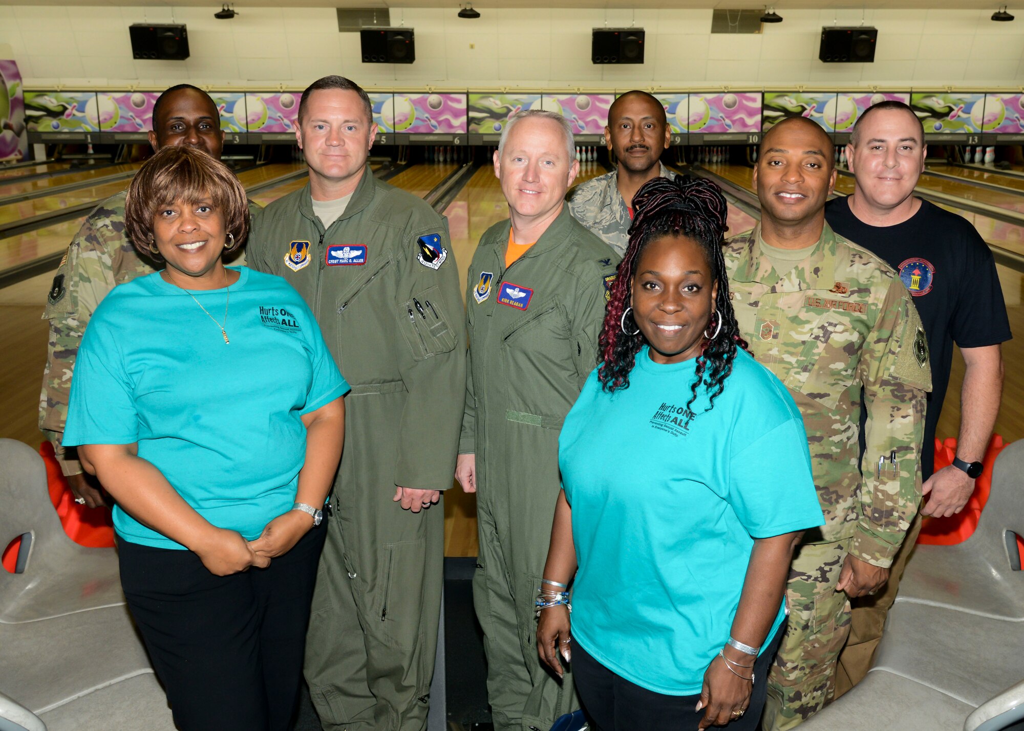 Carolyn Graves, Sexual Assault Response Coordinator (front, left), and Ebony Graves, Sexual Assault Prevention Response Victim Advocate (front, right), pose for a picture with senior leadership during the “Strike Out Sexual Assault” event at the High Desert Bowling Lanes on Edwards Air Force Base, California, Oct. 12. (U.S. Air Force photo by Giancarlo Casem)