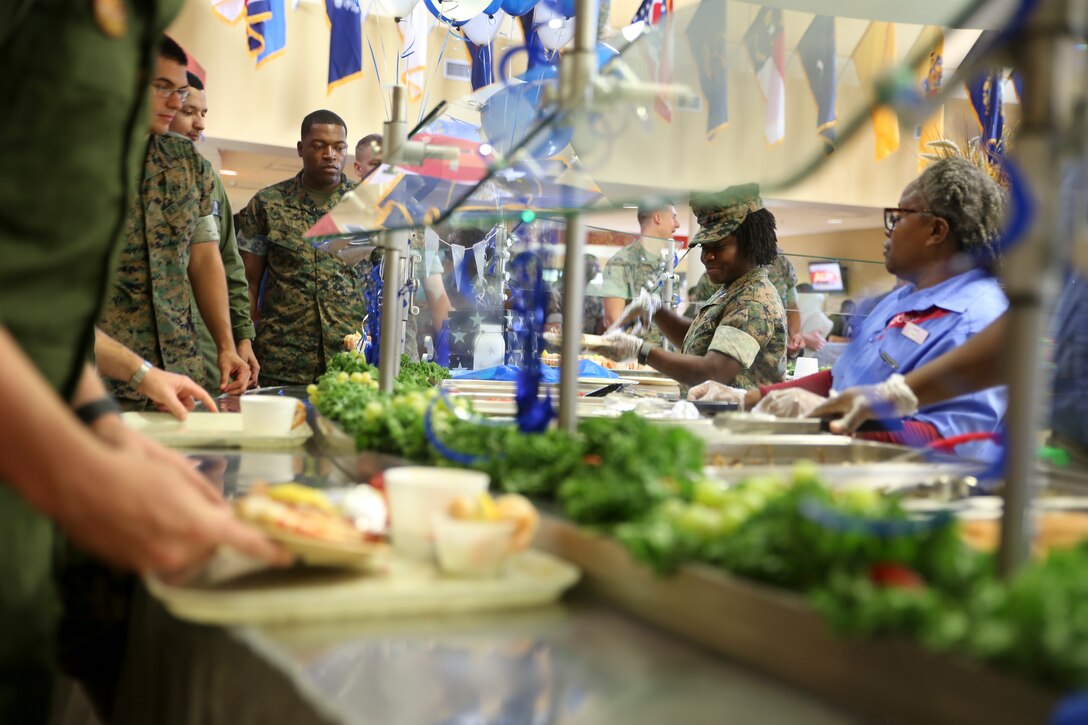 Capt. Veronica Abosi and mess hall workers serve food to Marines and Sailors during the Navy birthday celebration aboard Marine Corps Air Station Beaufort, Oct. 17. Abosi
is a supply officer with Headquarters and Headquarters Squadron aboard the air station.