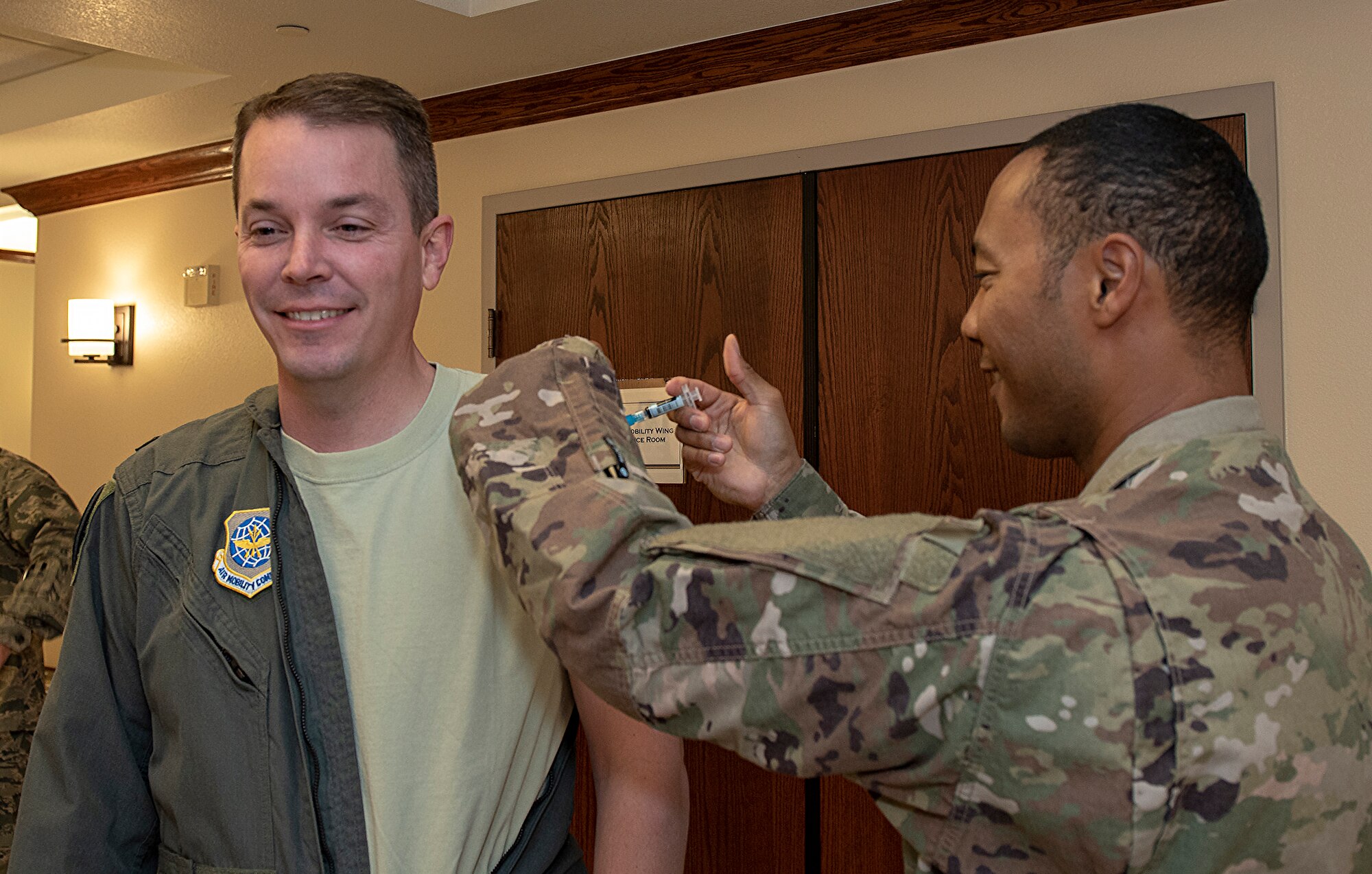 U.S. Air Force Col. Jeffrey Nelson, commander, 60th Air Mobility Wing is administered his seasonal influenza vaccination by Tech. Sgt. Levon Johnson, an independent medical technician currently assigned to the 6th Air Refueling Squadron, Oct. 10, 2018, Travis Air Force Base, Calif. (U.S. Air Force Photo by Heide Couch)