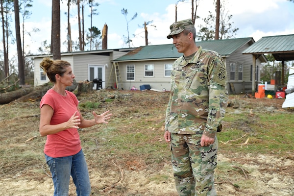 Kelly Bunting, U.S. Army Corps Engineers Park Ranger at the Lake Seminole Project, describes how her family survived Hurricane Michael to Col. Sebastien P. Joly during his visit to the family home on Oct. 16, 2018, in Sneads, Fla. The Buntings survived the Category 4 storm by riding out inside of a bulldozer.