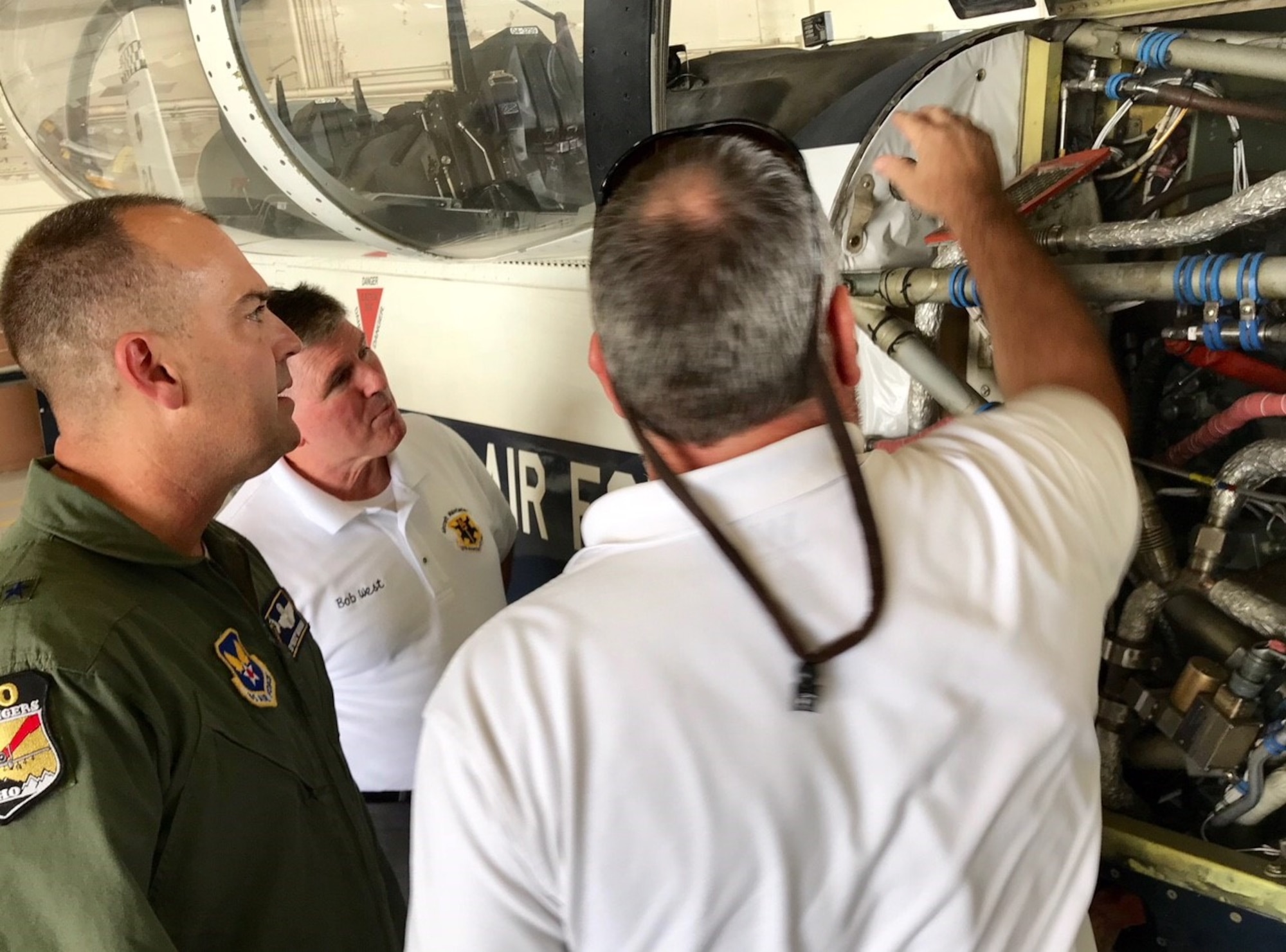 Brig. Gen. Ed “Hertz" Vaughan, the lead for the Air Force Physiological Events Action Team, and members of the 12th Flying Training Wing maintenance division examine an on-board oxygen generating system (OBOGS) from a T-6 aircraft at Randolph Air Force Base, Texas. (U.S. Air Force photo by Lt. Col. Kyle Goldstein)