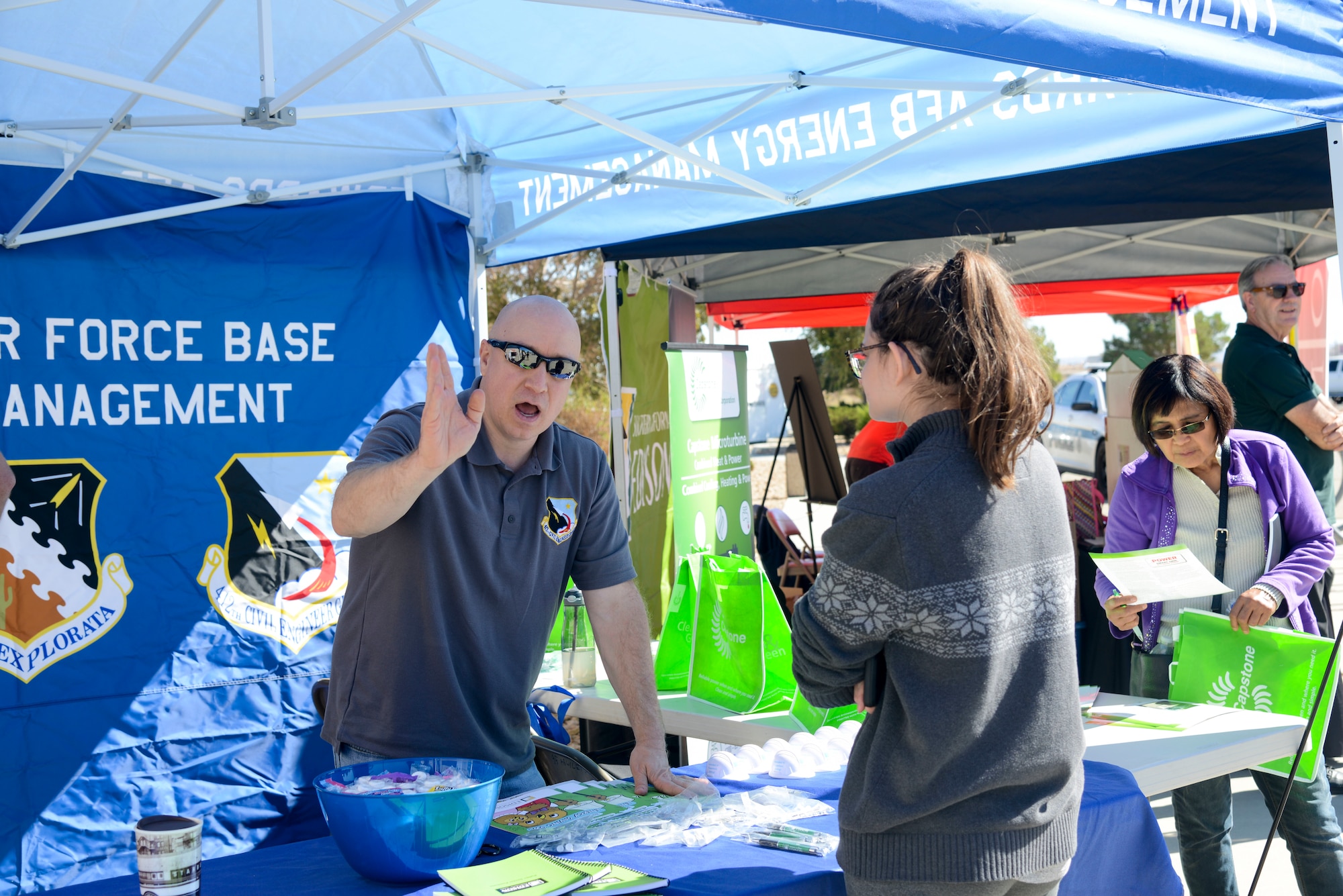 Richard Morris, 412th Civil Engineer Group Energy Management Section, talks with an Air Force spouse during the Energy Action Month event at the Base Exchange on Edwards Air Force Base, California, Oct. 17. (U.S. Air Force photo by Giancarlo Casem)