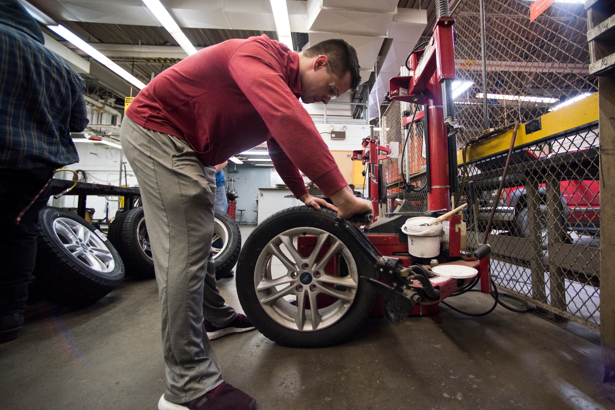 Bryce Ward, a University of Alaska Anchorage ROTC cadet, removes a summer tire from the rim at the Auto Skills Center at Joint Base Elmendorf-Richardson, Alaska, Oct. 17, 2018. The Auto Skills Center is home to a full array of equipment, tools and knowledgeable staff for do-it-yourself maintenance and repair to personal vehicles.