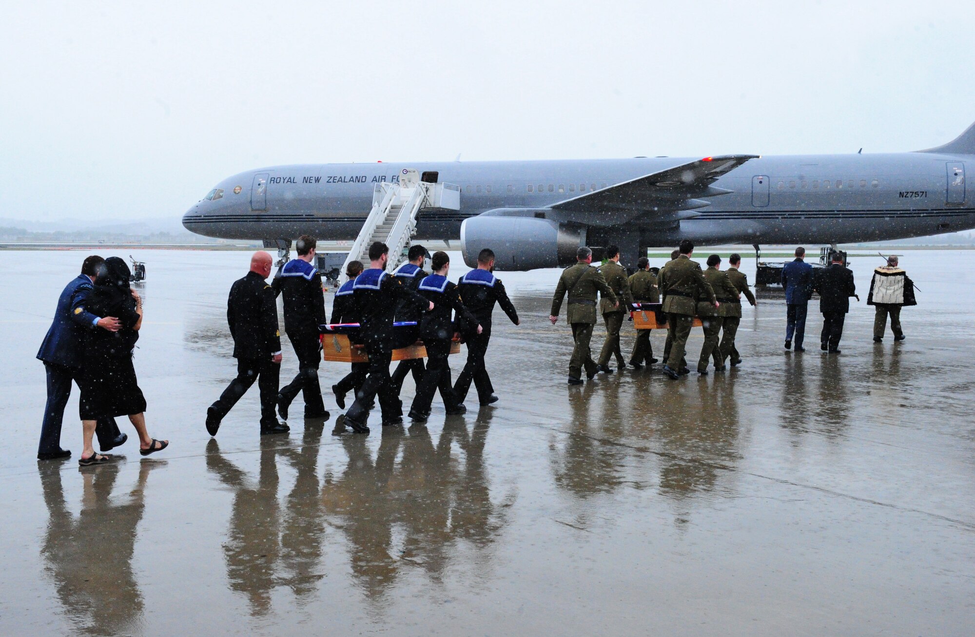 Members from the Maori Cultural Group and Pallbearers from the New Zealand Te Auraki Project escort remains of PJ Mollison and HL Herbert Lester Humm on the tarmac at Osan Air Base, Republic of Korea, Oct. 5, 2018. As part of a project called Te Auraki (The Return), the New Zealand Defense Force returns personnel and dependents buried overseas after January 1955 back home to New Zealand. (U.S. Army Sergeant Benjamin Parsons)