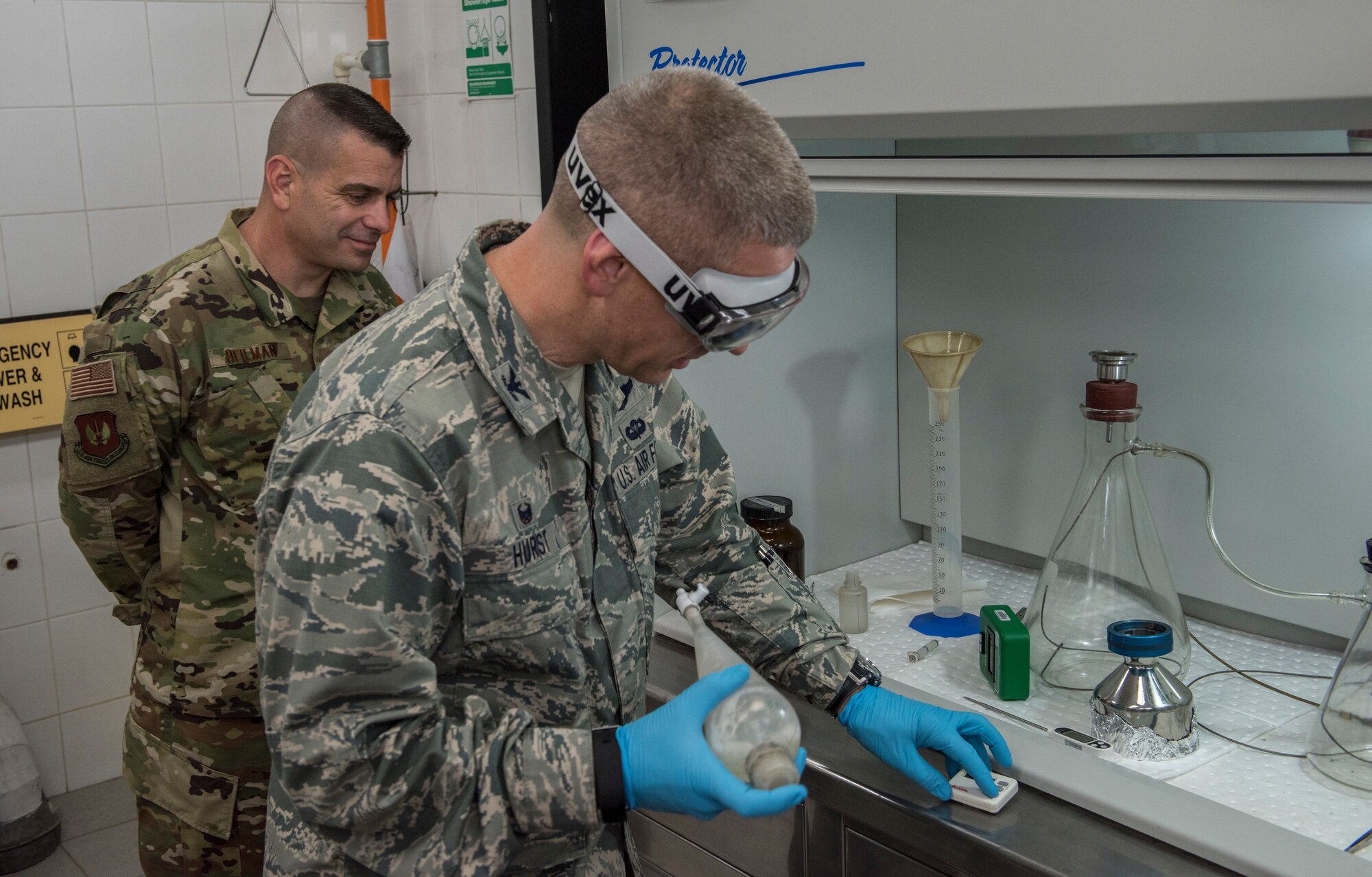 39th Air Base Wing commander and command chief participate in a fuel inspection with lab technicians.