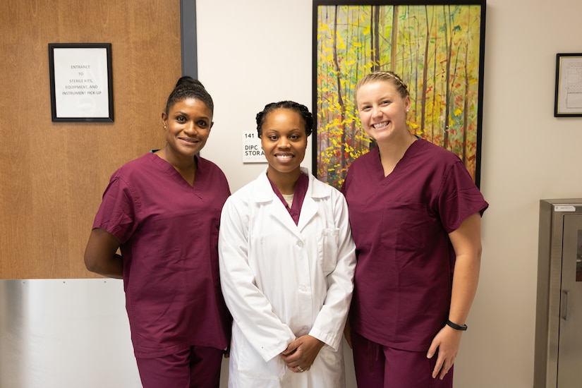 (Middle) U.S. Air Force Tech. Sgt. Angela Dunston, 633rd Dental Squadron Technician, poses with this year’s American Red Cross dental assistant program volunteers, Delci Davies and Megan Barnard at Joint Base Langley-Eustis, Virginia, Oct. 11, 2018. This six-month program provides hands on training for those interested in the dental field. (U.S. Air Force photo by 2nd Lt. Samuel Eckholm)