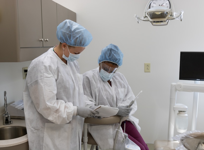 Megan Barnard and Delci Davies, 633rd Dental Squadron American Red Cross dental assistant program volunteers, prepare for an upcoming appointment at Joint Base Langley-Eustis, Virginia, Oct. 11, 2018. Volunteers selected for the program work full-time from 6:45 a.m. to 4:00 p.m. weekdays. (U.S. Air Force photo by 2nd Lt. Samuel Eckholm).