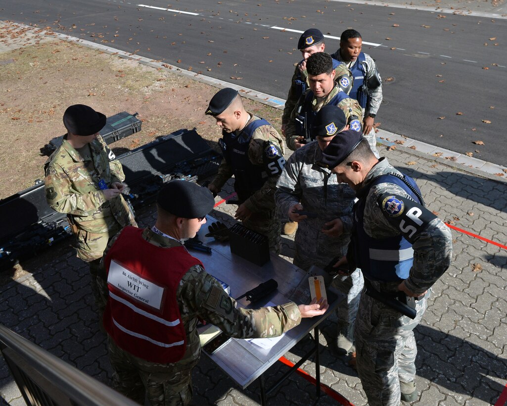 Security forces Airmen arrive on scene and clear their weapons during an active shooter exercise at Ramstein Airman Leadership School on Vogelweh Military Complex, Germany, Oct. 16, 2018. As security forces members approached the school house they were directed to a single point of entry to ensure the safety of all participants. (U.S. Air Force photo by Staff Sgt. Jimmie D. Pike)