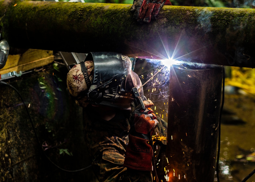 U.S. Marine Staff Sgt. Immanuel Garcia, a metal worker with Special Purpose Marine Air-Ground Task Force – Southern Command welds a support beam to support the pipe the Marines are replacing on Sep 19, 2018 in Trujillo, Honduras. The water valve was stuck at 80% shut-off effecting 6 local communities containing roughly 8,000 people. The Marines repaired the pipe to return water to the local communities. The Marines and sailors of SPMAGTF-SC are conducting security cooperation training and engineering projects alongside partner nation military forces in Central and South America. The unit is also on standby to provide humanitarian assistance and disaster relief in the event of a hurricane or other emergency in the region.