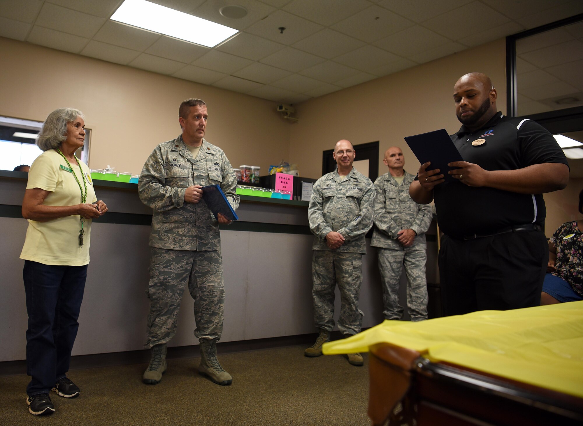 Elisa Quintero, 14th Force Support Squadron Youth Programs operations clerk, is read her Certificate of Service, thanking her for 50 years of service under the Air Force, August 13, 2018, on Columbus Air Force Base, Mississippi. (U.S. Air Force photo by Airman 1st Class Keith Holcomb)
